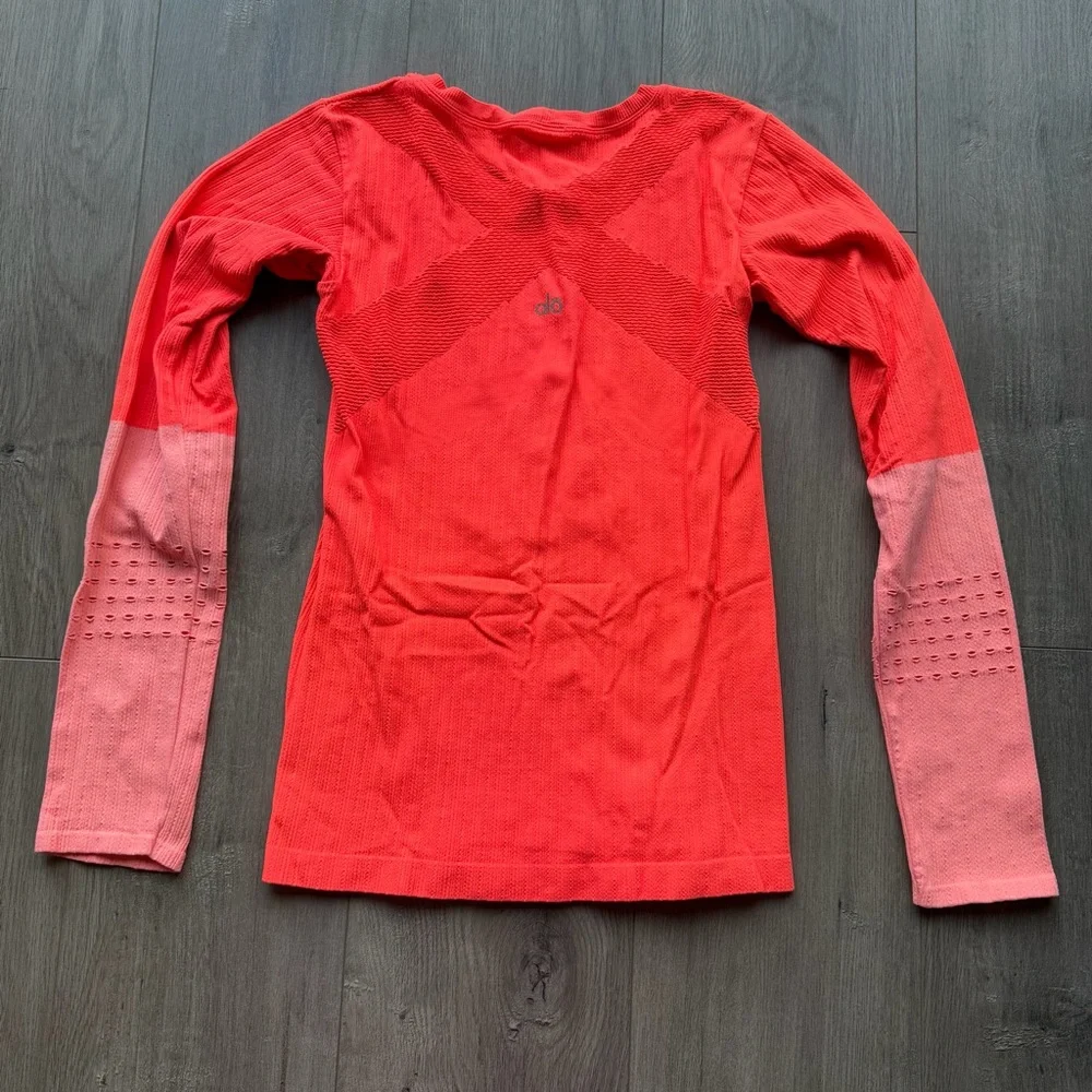 EUC Alo Yoga Exhale long sleeve top in neon orange/light pink